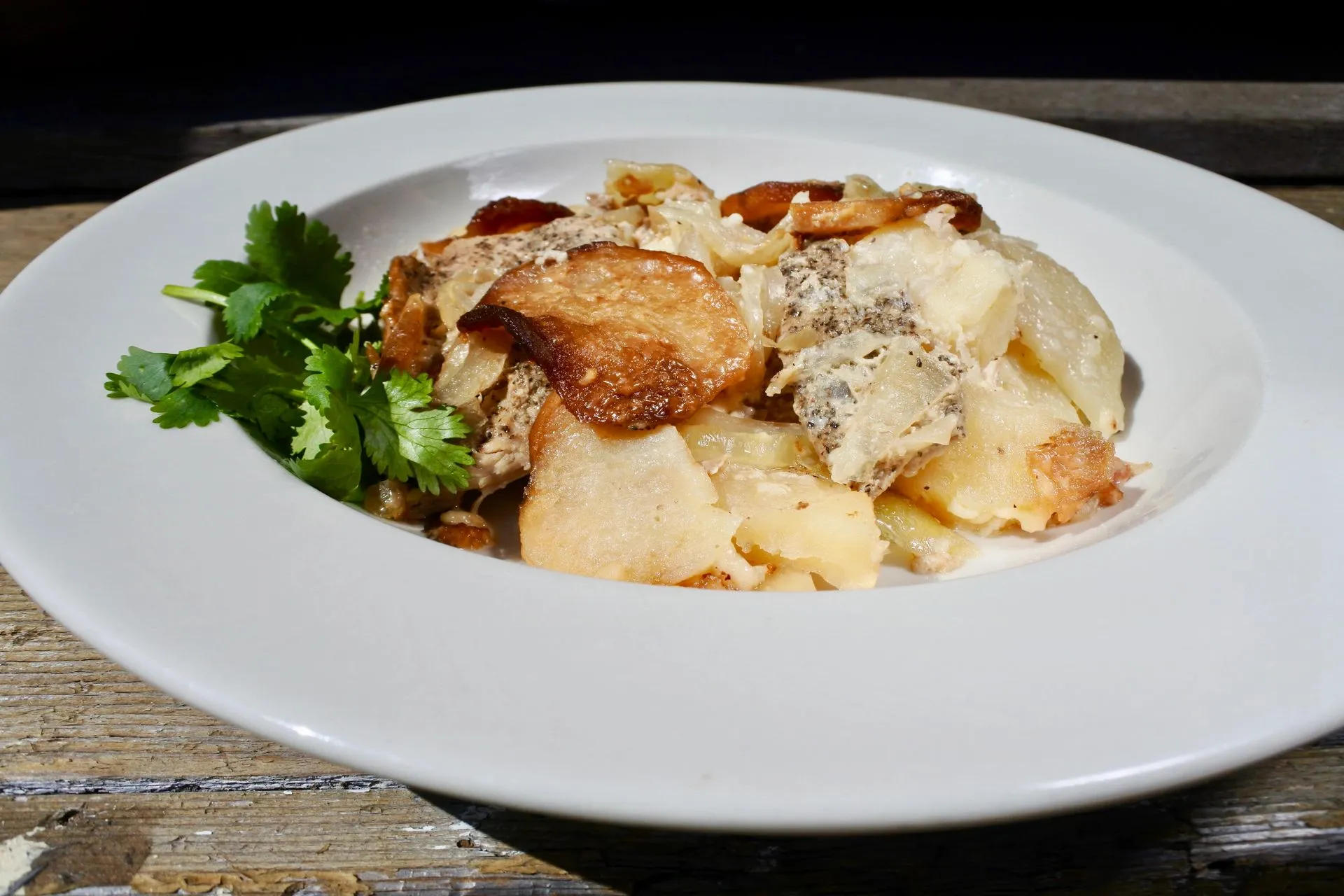 Layered pork and potato — baked with onions and mozzarella cheese