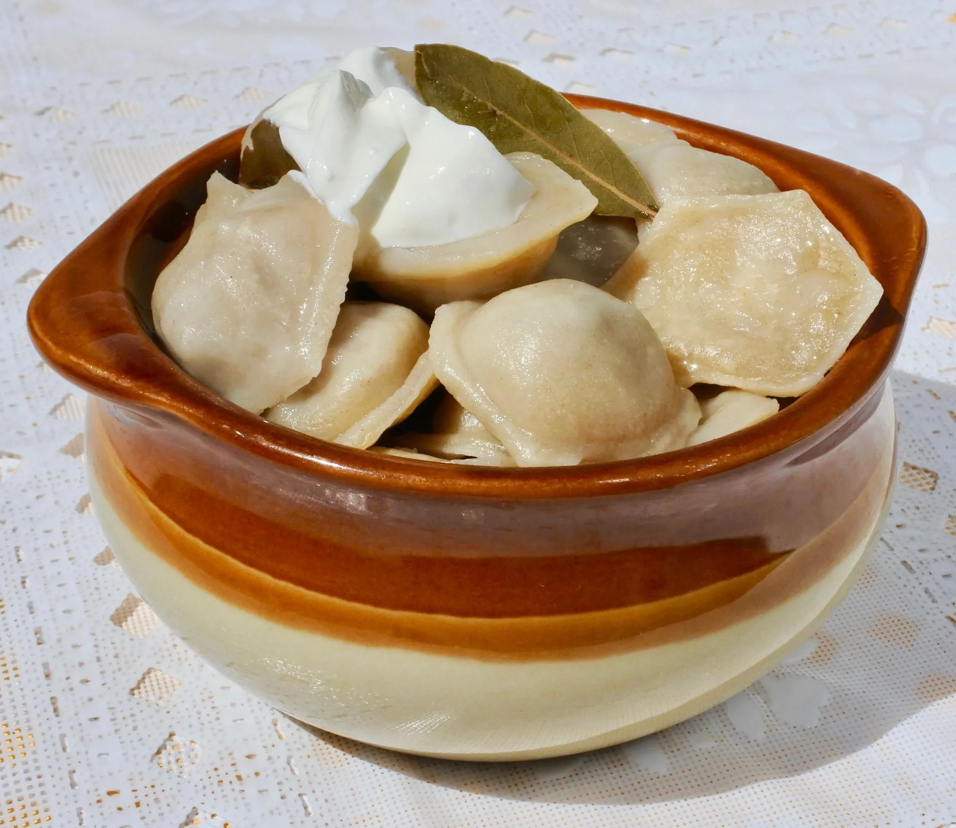 Handmade Siberian pelmeni dumplings with sour cream